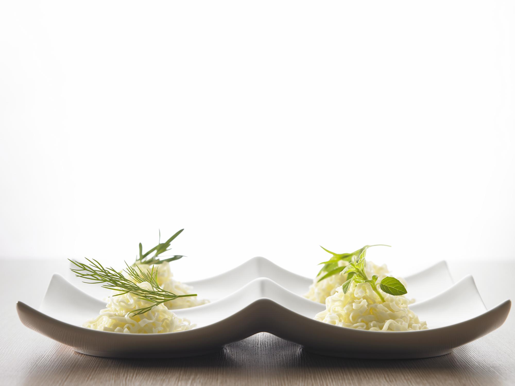 Chef preparing plated dish on wooden table